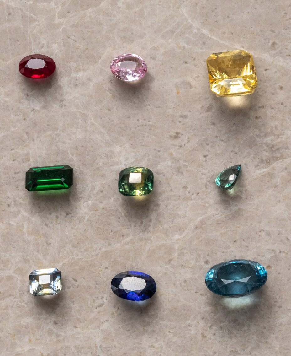 Loose sapphire gemstones in various colours including blue, pink, yellow and green in different cuts and shapes