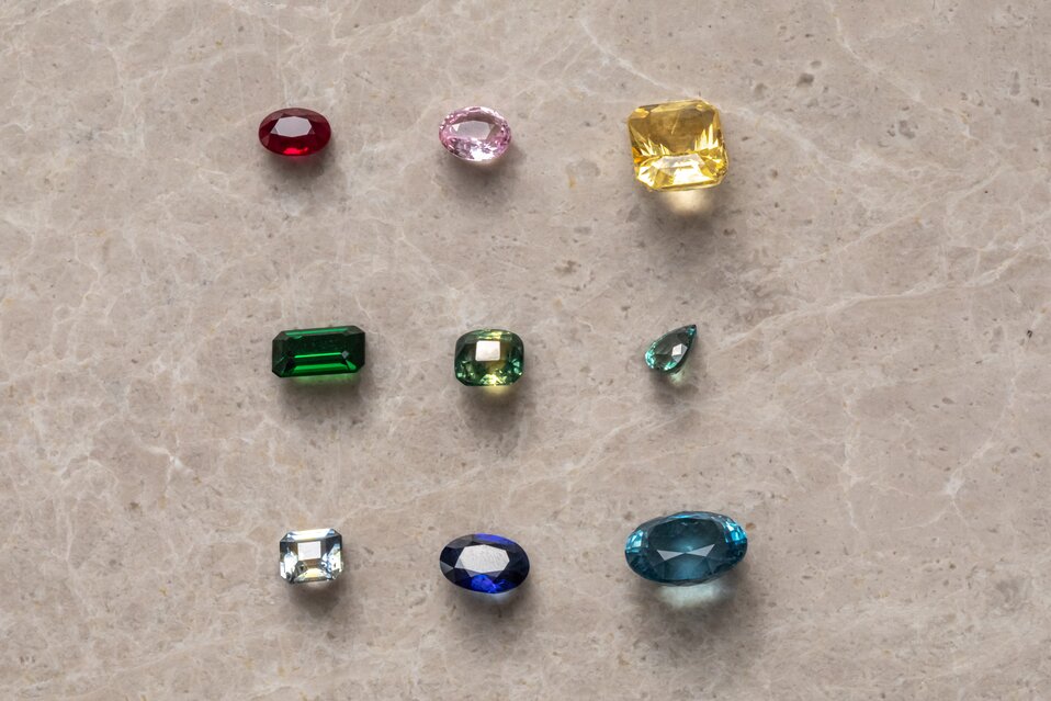 A collection of colorful gemstones featuring various shapes, cuts, and rich organic colors.