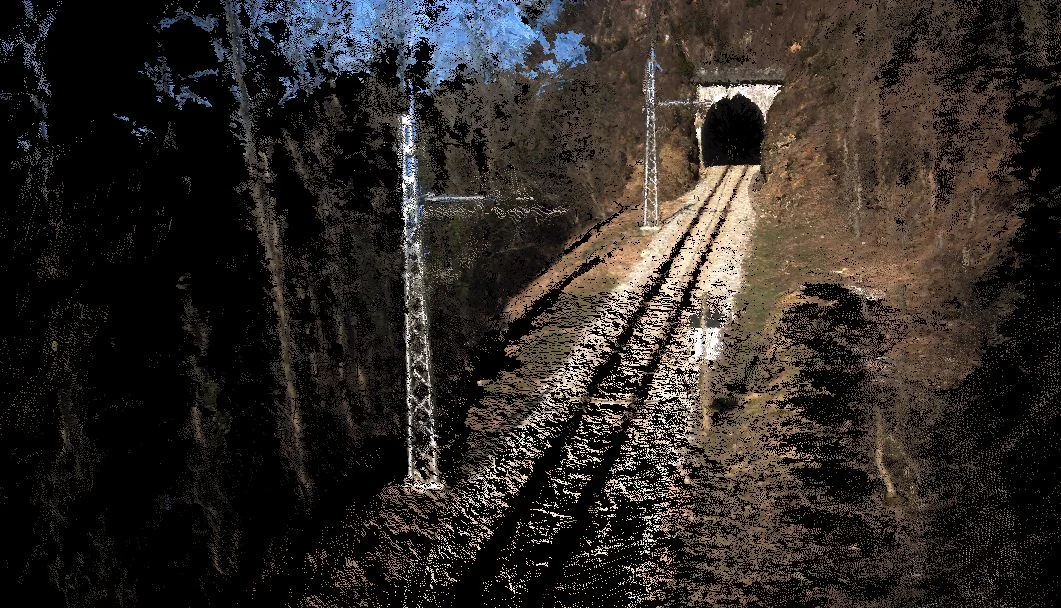 Railway track leading to a tunnel reconstructed as a 3D point cloud