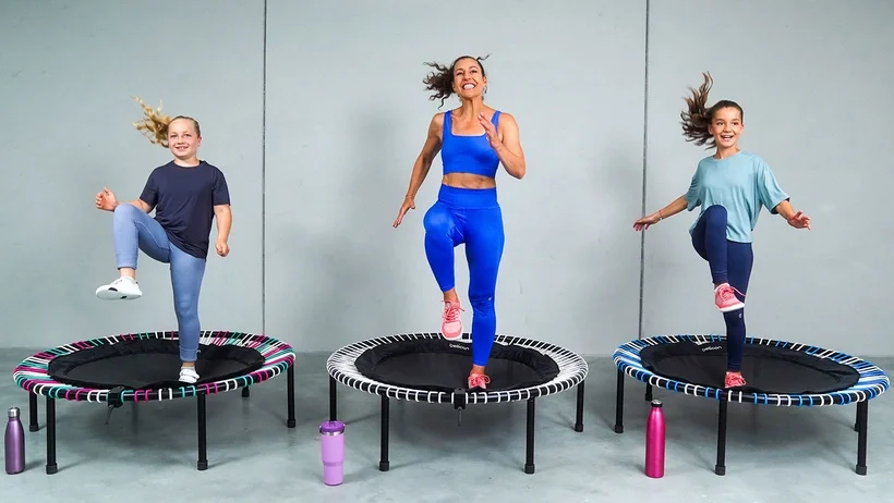 Two children jumping sideways on the bellicon rebounder. 