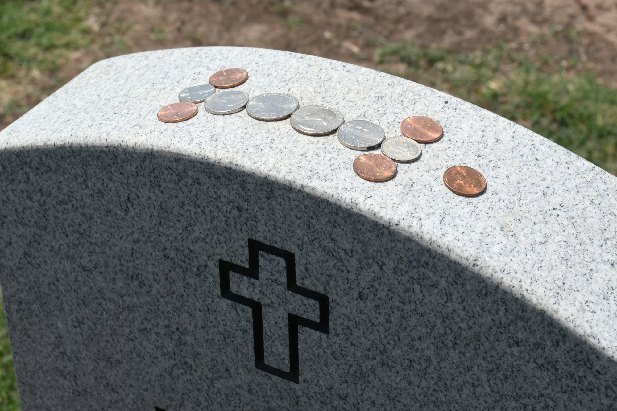 What Do Those Coins Left on Soldiers’ Graves Actually Mean?