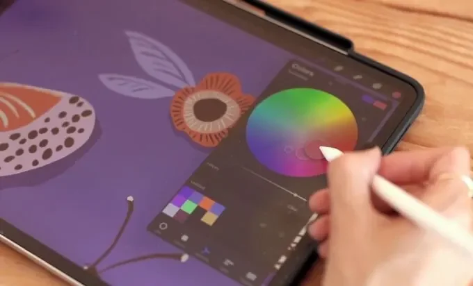 A person drawing on a tablet with a pencil, focused on creating digital ...