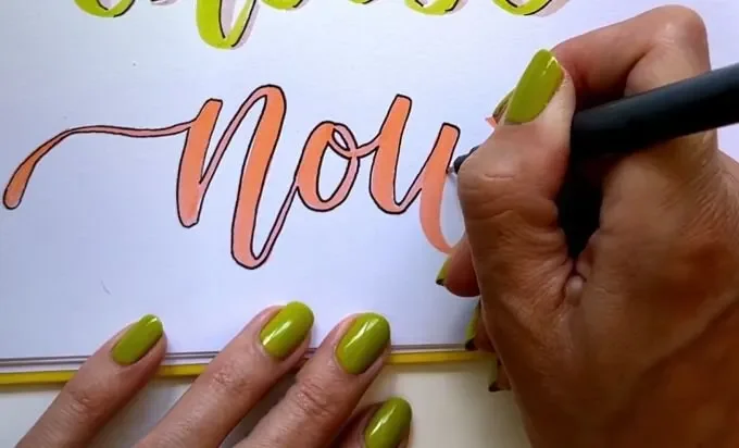 A person writes the word 