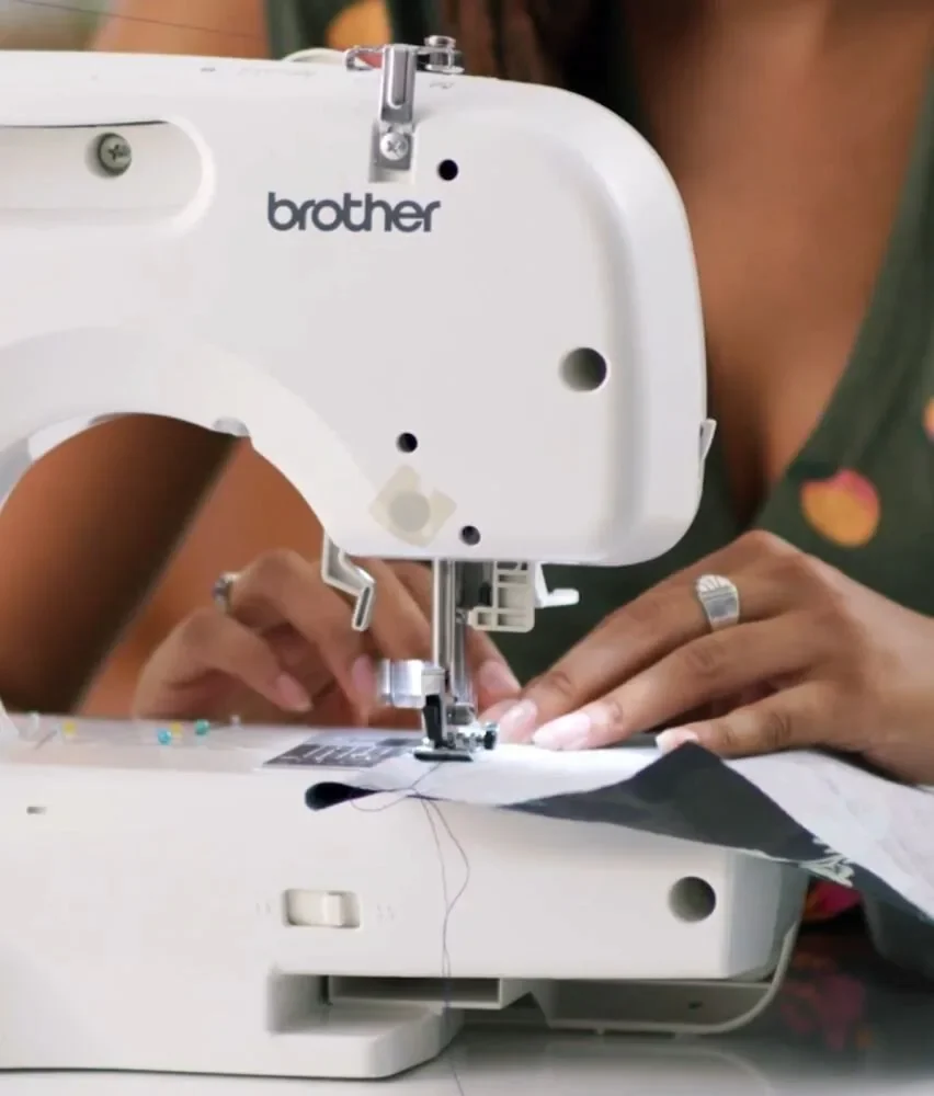 Woman using a Brother sewing machine to create a garment, showcasing ...