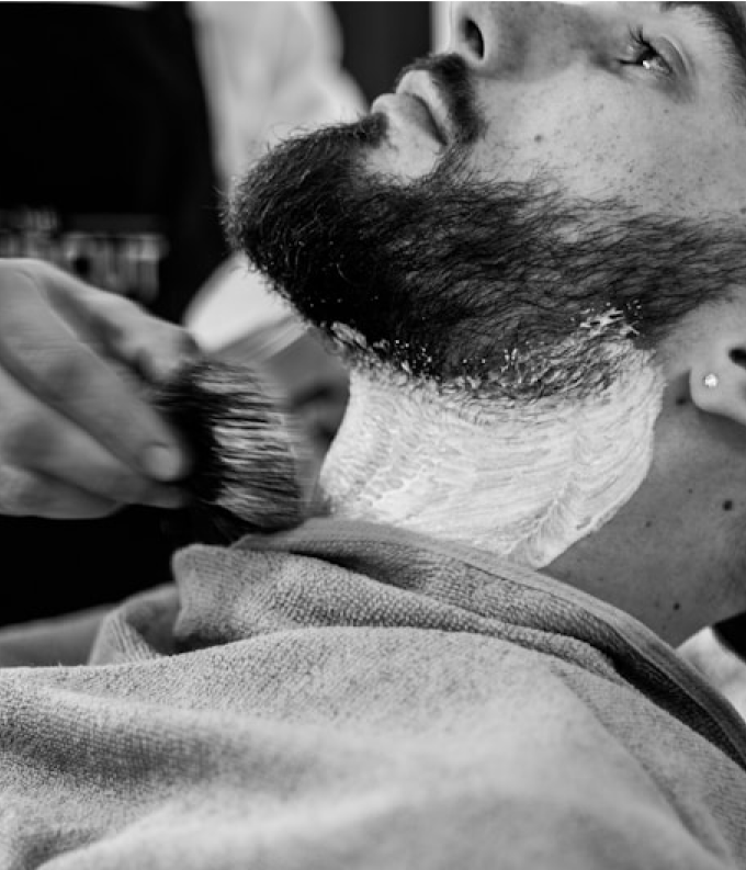 Hot towel shaving service illustration showing traditional straight razor shave