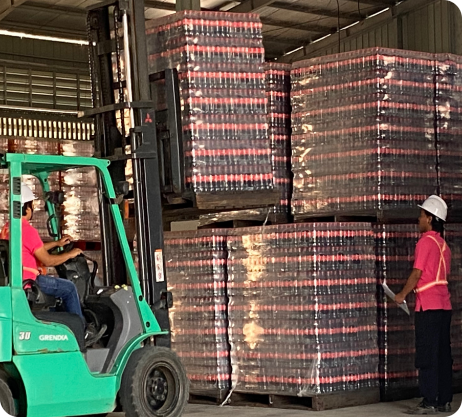 Warehouse operations: forklift loading beverage pallets for distribution.