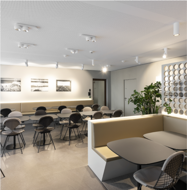 Modern Oettinger Davidoff cafeteria at Maison Davioff with elegant tables and chairs that create an inviting atmosphere.