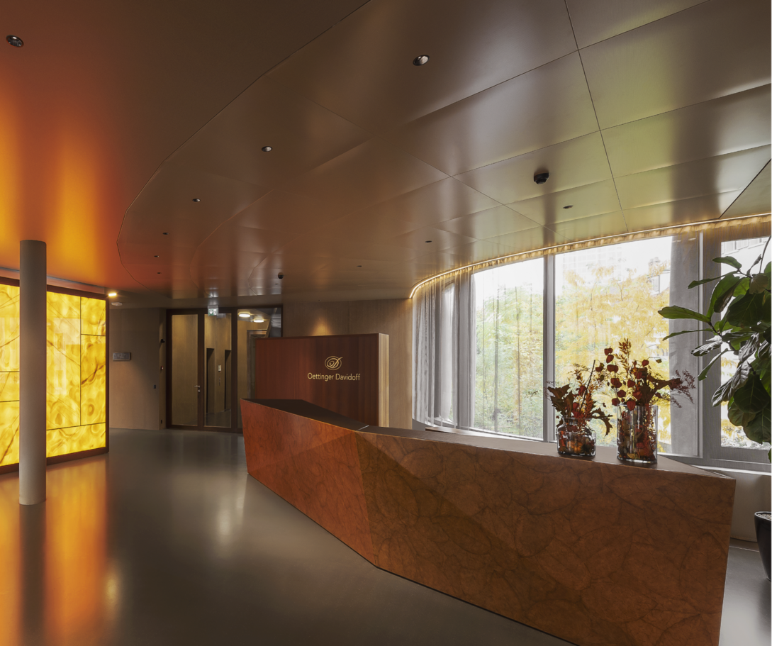 A long corridor with a reception desk and a plant that creates an inviting atmosphere.