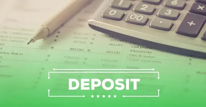 Pen and calculator on sheet of paper showing budget with word "deposit" on bottom