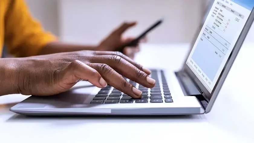 hands typing on laptop 