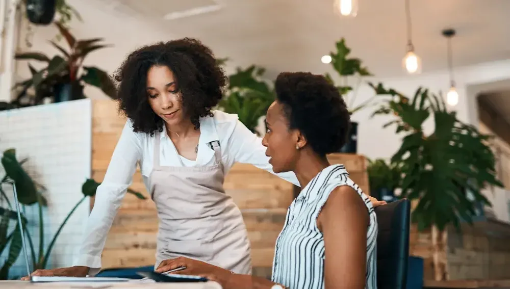 women discussing business in a cafe