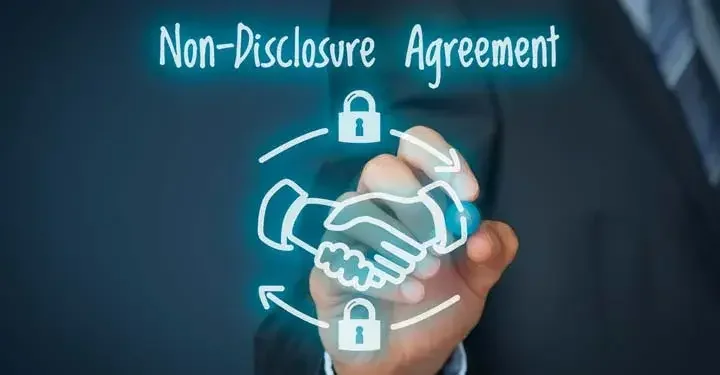 Hand writing the words "Non-Disclosure Agreement" on the screen