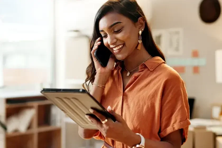 A small business owner talks on her phone to her attorney while looking at BOIR requirements on her iPad. Reporting companies created or registered on or after January 1, 2024, have to include information about company applicants in their BOI reports, and they have a shorter filing window than existing companies formed before 2024.