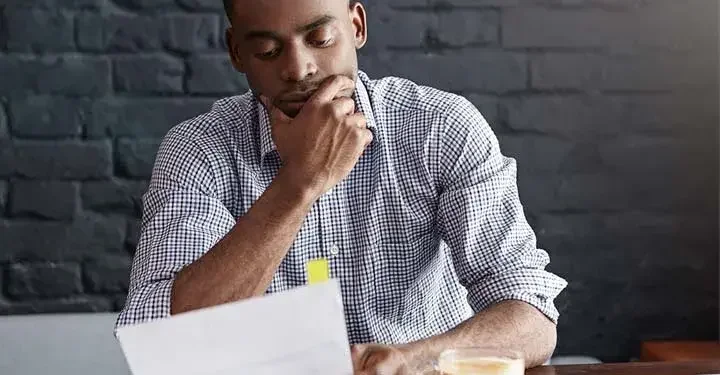 Man at table reading document