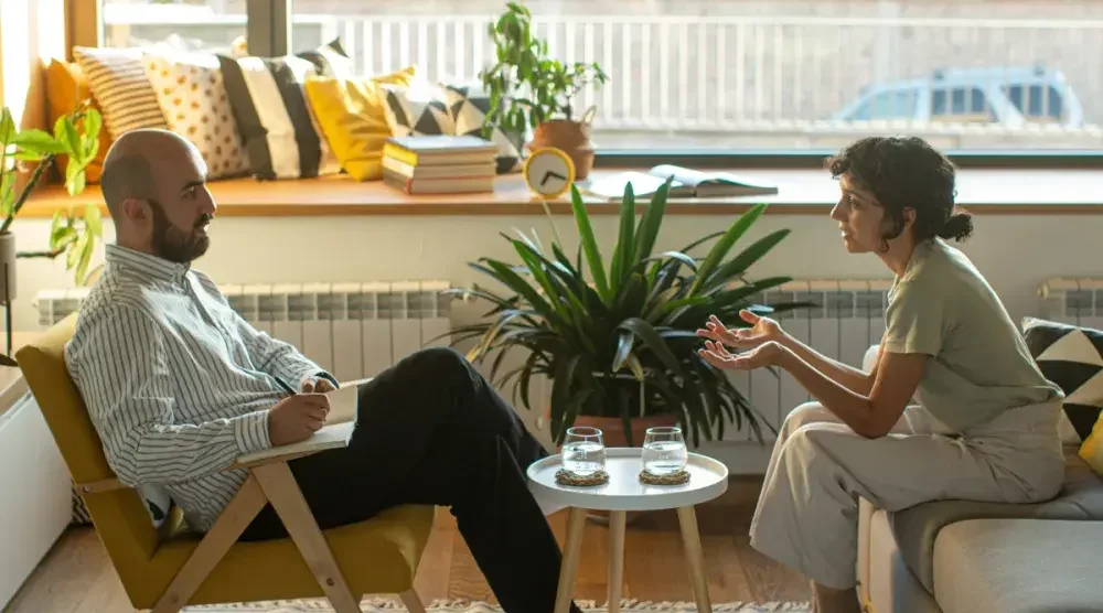 A man and a woman sit in chairs opposite each other as they discuss getting a divorce in their home state of South Carolina.