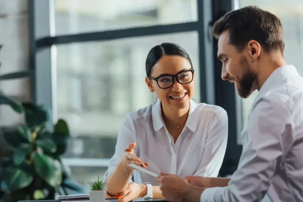 A tax professional meets with a small business owner to go over his tax forms.