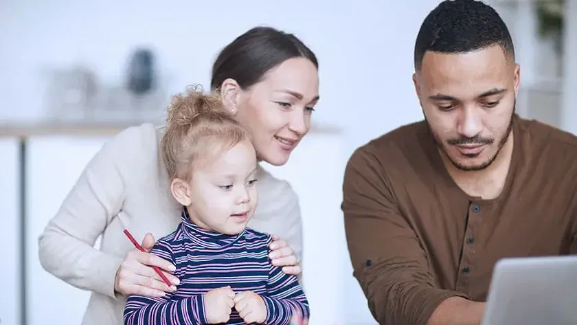 family-looking-at-computer-smiling