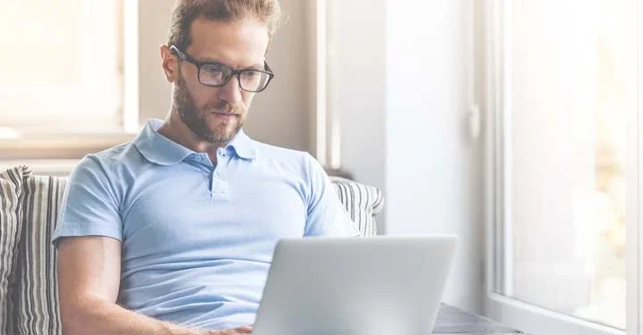 man researching on laptop how to buy a house while getting divorced