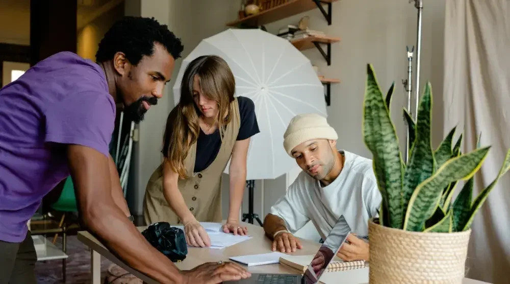 Three West Virginia business partners sort through business documents in their photography studio.