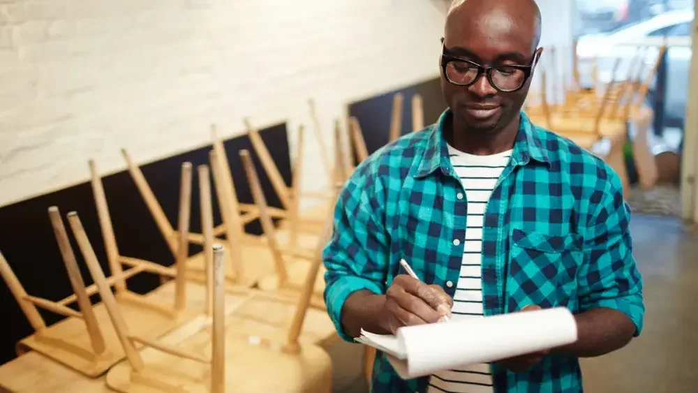 A small business owner gathers paperwork for his tax appointment.