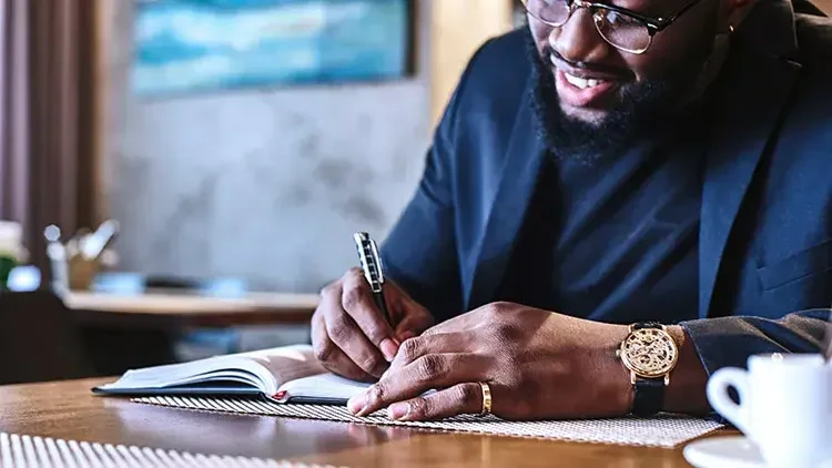 Man writing in notebook