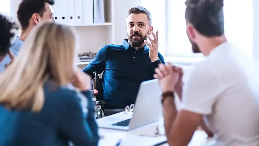 Business people discuss ideas in office