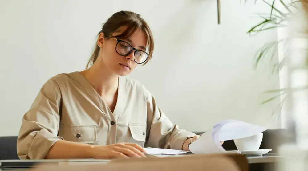 A small business owner in Illinois examines her profit and loss records before filing her annual report with the state.