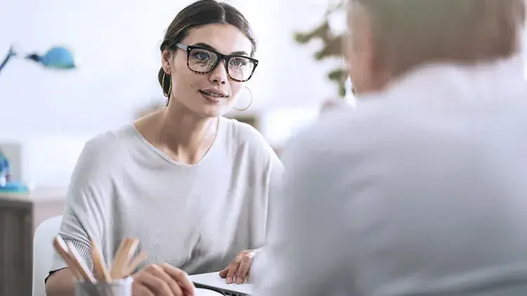 Woman consults client in office