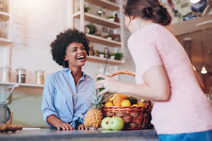 A woman interacting with a customer from behind a counter