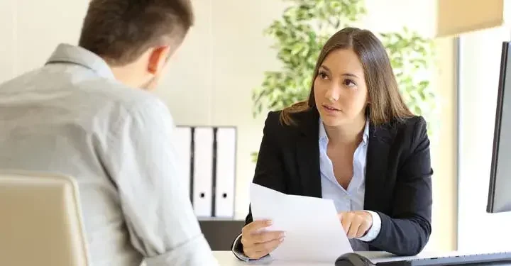 Businesswoman reviewing paperwork with a coworker