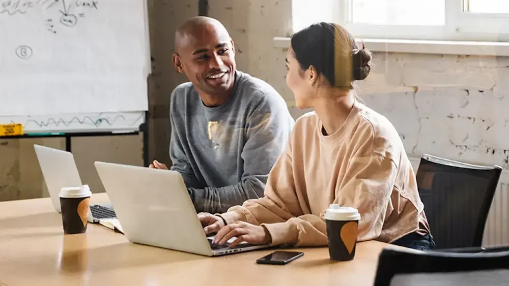 Co-owners of a new business sit at a conference room table discussing their Florida LLC. The simplicity of forming an LLC in Florida is another enticing factor for entrepreneurs.