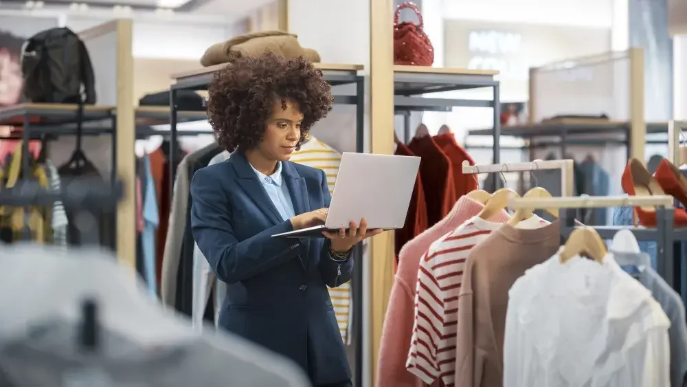 woman looking at laptop standing in a store 