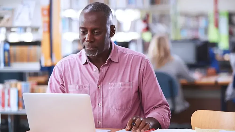 A man reads about beneficial ownership and how it applies to his small business before he files his report online.