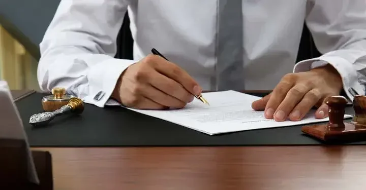 Businessman's hands signing a document