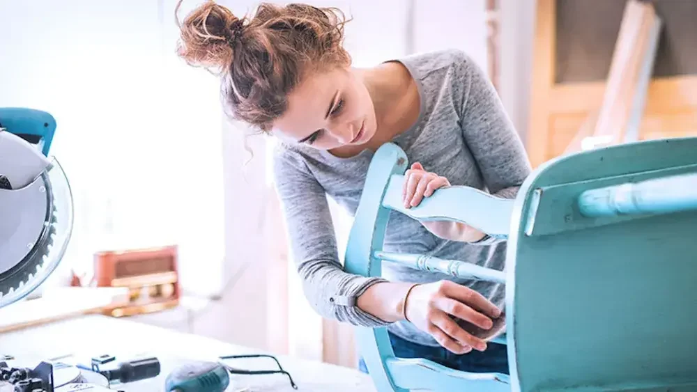 There are many advantages to choosing an LLC, as this new business owner, sanding a chair in her workshop, has learned.