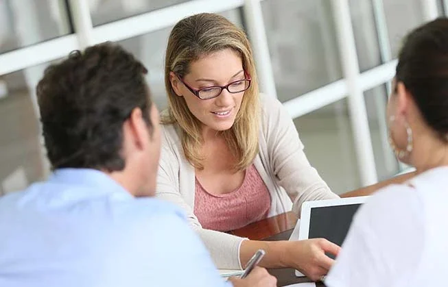 Three people at desk