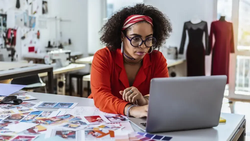 woman looking at laptop in artist studio