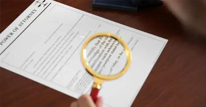 "Power of Attorney" document under magnifying glass