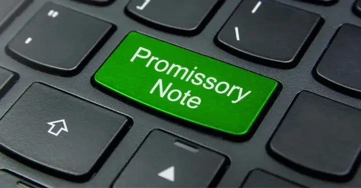 Laptop keyboard with a key labeled "Promissory Note"