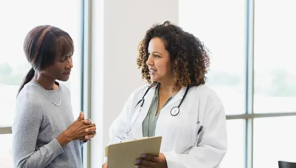 A woman and her doctor discuss her healthcare power of attorney.