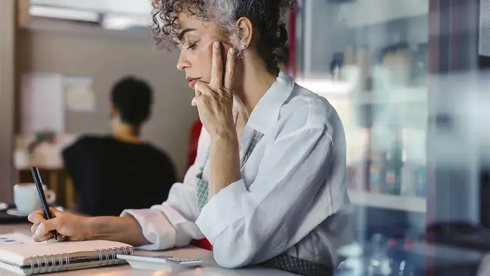 woman writing in workbook