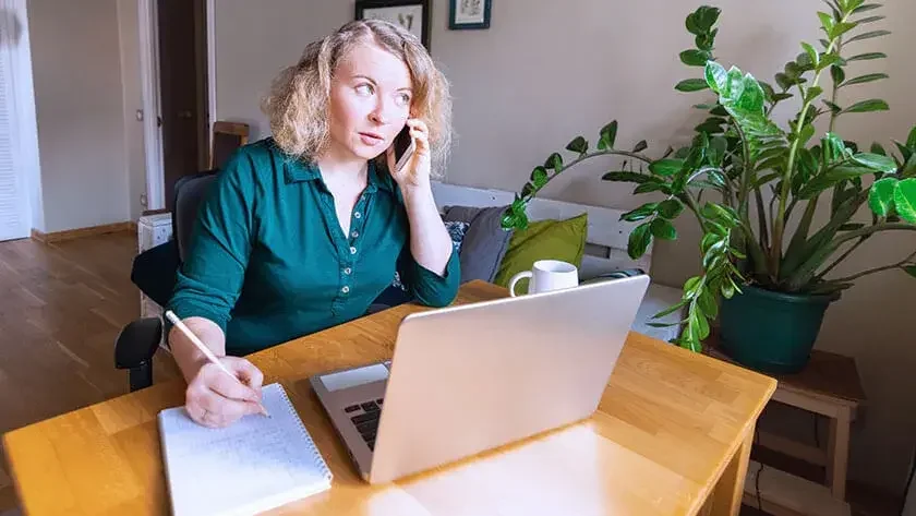 woman-talking-on-phone-home-office