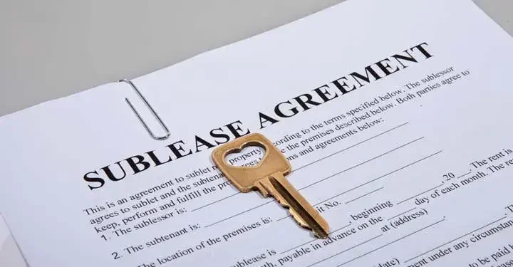 key sitting on top of a sublease agreement 