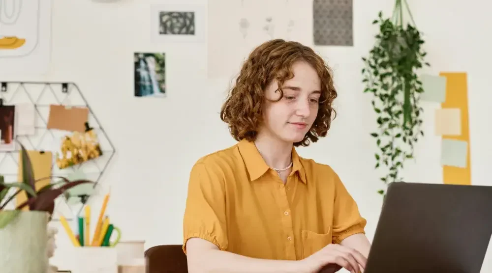 A woman works on her laptop computer. Aspiring business owners in Wisconsin need to make sure their business name is unique. Doing a business name search via the Secretary of State's office is a first step.