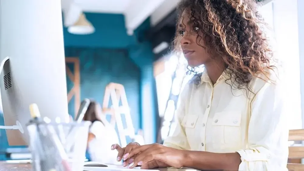 A woman checks online to see if the name she wants to use for her new business is available.