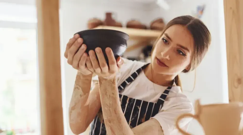 A ceramicist puts finishing touches on a bowl she will sell on Etsy. State, county, or municipal government might require a business license for your online business, even if products are sold on Etsy and nowhere else.