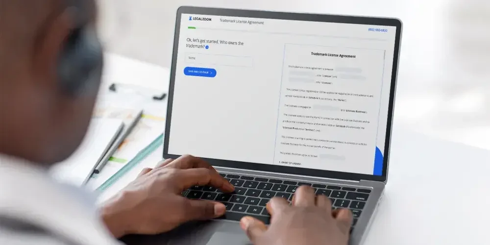 Someone uses a computer to fill out the LegalZoom trademark license template.