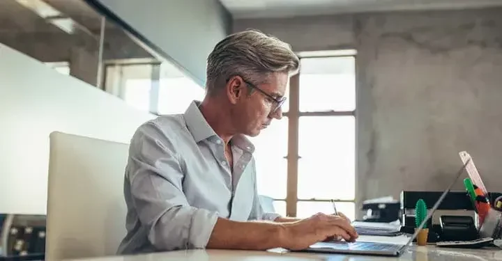 man working on laptop in home office 