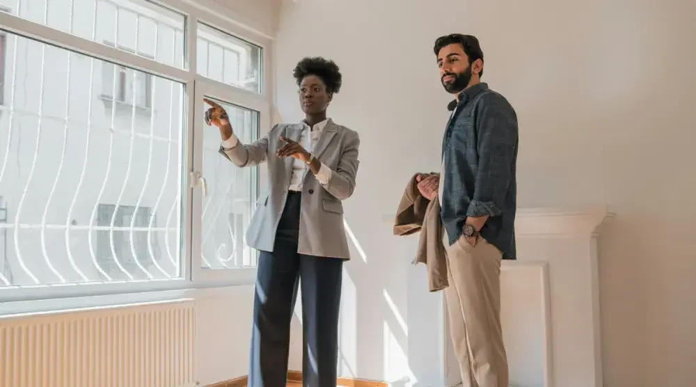 A licensed real estate agent shows a client a space that he could use as an investment.