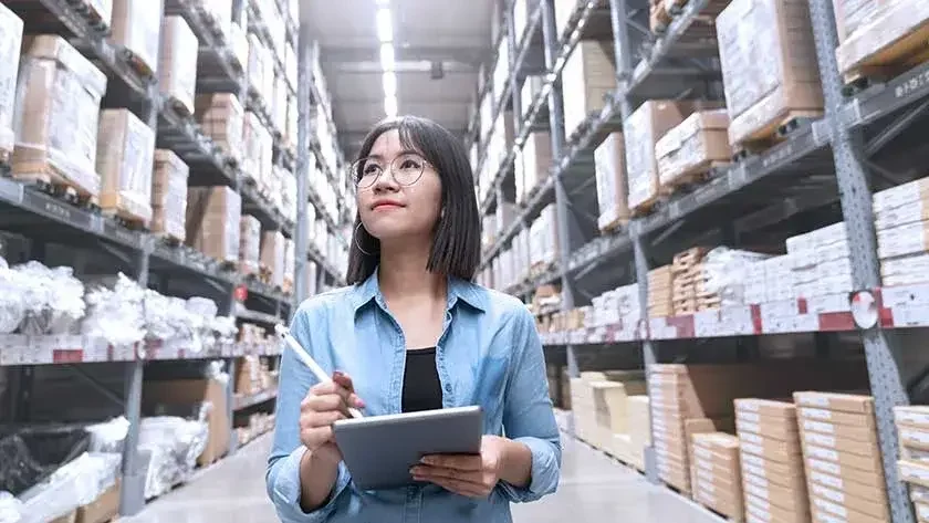 Woman taking stock in warehouse